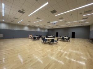 large open room showing round tables with chairs