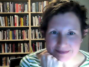 Shannon Mattern headshot in front of book case